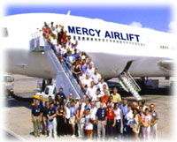 Volunteer boarding Mercy Airlift airplane